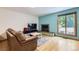 Comfortable living room features fireplace, hardwood floors and calming blue accent wall at 800 Illinois St # 1, Golden, CO 80401