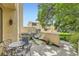 An outdoor patio area with dining table, chairs, and a small barbecue grill set among the green yard at 800 Illinois St # 1, Golden, CO 80401