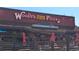 Exterior of Woody's Wood Fired Pizza, featuring outdoor seating and festive decorations at 800 Illinois St # 1, Golden, CO 80401