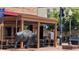 Outdoor dining with a buffalo statue, part of Golden's charm at 800 Illinois St # 1, Golden, CO 80401