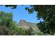 A scenic view of a majestic mountain peak framed by lush greenery, inviting exploration and natural beauty at 800 Illinois St # 1, Golden, CO 80401