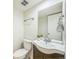 Cozy half bathroom featuring a vessel sink with large mirror and silver hardware at 1219 S Yosemite Way # 63, Denver, CO 80247