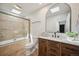 Updated bathroom with a glass enclosed shower, vanity with natural wood cabinets, and modern fixtures at 1219 S Yosemite Way # 63, Denver, CO 80247