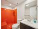 Unique bathroom featuring bright orange shower, toilet, and dark vanity sink at 1219 S Yosemite Way # 63, Denver, CO 80247