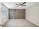 A bedroom featuring a brick wall, a ceiling fan, carpeted flooring and a window for natural light at 1219 S Yosemite Way # 63, Denver, CO 80247