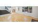 Bright living room featuring hardwood floors, large windows, and access to kitchen and upstairs at 1219 S Yosemite Way # 63, Denver, CO 80247