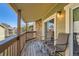 Spacious balcony with two chairs and sliding glass door access at 3452 S Eagle St # 201, Aurora, CO 80014