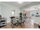 Bright dining area with glass table and four chairs, adjacent to kitchen and living room at 521 E 14Th Ave # 18, Denver, CO 80203