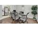 Dining area with glass top table and four chairs, looking toward kitchen at 521 E 14Th Ave # 18, Denver, CO 80203