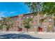 Brick apartment building with red doors and landscaping at 521 E 14Th Ave # 18, Denver, CO 80203