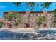 Brick apartment building with red doors and landscaping at 521 E 14Th Ave # 18, Denver, CO 80203