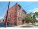 Brick apartment building with red doors and landscaping at 521 E 14Th Ave # 18, Denver, CO 80203