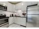 Modern kitchen with white cabinets, stainless steel appliances, and a breakfast bar at 521 E 14Th Ave # 18, Denver, CO 80203