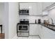 Kitchen with white cabinets, stainless steel appliances and subway tile backsplash at 521 E 14Th Ave # 18, Denver, CO 80203