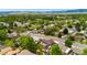 Wide aerial shot of the neighborhood with lush greenery and mountain views at 7350 Devinney Ct, Arvada, CO 80005
