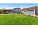 Well manicured backyard, with a deck, shed, and privacy fence at 7350 Devinney Ct, Arvada, CO 80005