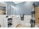 Stylish bathroom featuring a framed mirror and shower and modern fixtures at 7350 Devinney Ct, Arvada, CO 80005