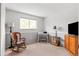 Comfortable bedroom offering a peaceful retreat with a rocking chair and lots of sunlight at 7350 Devinney Ct, Arvada, CO 80005