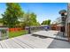 Wide deck with seating, umbrella, and grey wash at 7350 Devinney Ct, Arvada, CO 80005