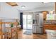 Bright kitchen with stainless steel appliances, light wood floors, and access to the back deck at 7350 Devinney Ct, Arvada, CO 80005