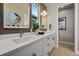 Modern bathroom with dual sinks, sleek white cabinets, and contemporary design at 1793 W 166Th Ave, Broomfield, CO 80023
