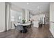 Contemporary dining area with round table, stylish chairs, and natural light from a large window at 1793 W 166Th Ave, Broomfield, CO 80023