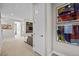 Hallway leading to living room featuring neutral carpet, modern artwork, and recessed lighting at 1793 W 166Th Ave, Broomfield, CO 80023
