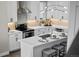 Modern kitchen features white cabinets, quartz countertops, stainless steel appliances and a cozy breakfast bar with seating at 1793 W 166Th Ave, Broomfield, CO 80023