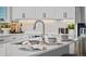 Close-up of the kitchen island's sink, countertop, and faucet at 1793 W 166Th Ave, Broomfield, CO 80023