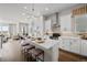 Modern kitchen island with bar stool seating, a sink, and stainless steel appliances at 1793 W 166Th Ave, Broomfield, CO 80023
