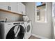 Convenient laundry area equipped with new, white, Whirlpool washer and dryer at 1793 W 166Th Ave, Broomfield, CO 80023