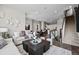 Bright, open-concept living room features modern decor, hardwood floors, and staircase access at 1793 W 166Th Ave, Broomfield, CO 80023