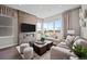 Comfortable living room with a modern fireplace, a large window, and stylish furniture at 1793 W 166Th Ave, Broomfield, CO 80023
