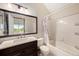 Bathroom featuring vanity with dark cabinets and marble countertop, and a bathtub with shower at 16901 E Chenango Ave # E, Aurora, CO 80015