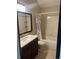 Cozy bathroom showcasing a vanity, mirror, and combined tub and shower with decorative shower curtain at 16901 E Chenango Ave # E, Aurora, CO 80015