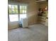 Versatile carpeted room with large window and built-in shelving for storage or display at 16901 E Chenango Ave # E, Aurora, CO 80015