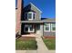 Charming two-story townhome with well-maintained front yard and gray and brick facade under a blue sky at 16901 E Chenango Ave # E, Aurora, CO 80015
