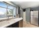 Well-lit kitchen features a stainless steel refrigerator and a double basin sink at 16901 E Chenango Ave # E, Aurora, CO 80015