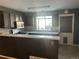 Modern kitchen features tiled backsplash, stainless appliances, and breakfast bar for casual dining at 16901 E Chenango Ave # E, Aurora, CO 80015