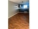 Stylish living area with wood flooring, neutral walls, and an open layout to the modern kitchen at 16901 E Chenango Ave # E, Aurora, CO 80015