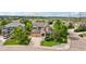 Lovely aerial view of a brick and tan two-story home with a well-manicured lawn and a two car garage at 641 Briar Haven Dr, Castle Pines, CO 80108