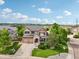 Stunning aerial view of a brick and tan two-story home with a well-manicured lawn and a two car garage at 641 Briar Haven Dr, Castle Pines, CO 80108