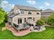 Well-designed backyard with a raised deck, stone patio, fire pit, and a lush green lawn, great for outdoor living at 641 Briar Haven Dr, Castle Pines, CO 80108