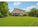 Expansive backyard featuring a large, well-maintained lawn, wooden fence, a deck and stone patio area at 641 Briar Haven Dr, Castle Pines, CO 80108