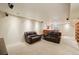Spacious basement with a cozy entertainment area, two couches, and a bar area at 641 Briar Haven Dr, Castle Pines, CO 80108