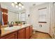Large bathroom with dual sinks, tile floors, and a shower/tub combo at 641 Briar Haven Dr, Castle Pines, CO 80108