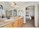 A luxurious ensuite bathroom with dual sinks, granite counters, and a tiled walk-in shower at 641 Briar Haven Dr, Castle Pines, CO 80108