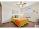 Bright bedroom with a ceiling fan, decorative accents, and a large window with bright light at 641 Briar Haven Dr, Castle Pines, CO 80108