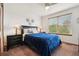 Tranquil bedroom with plush carpet, side tables with lamps, and a view out the window at 641 Briar Haven Dr, Castle Pines, CO 80108