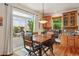Inviting dining area with a wooden table set, adjacent to a sliding door opening to a deck at 641 Briar Haven Dr, Castle Pines, CO 80108